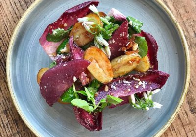 Jersey Royals with red wine poached pear, chicory and watercress salad, Cornish blue & candied walnuts